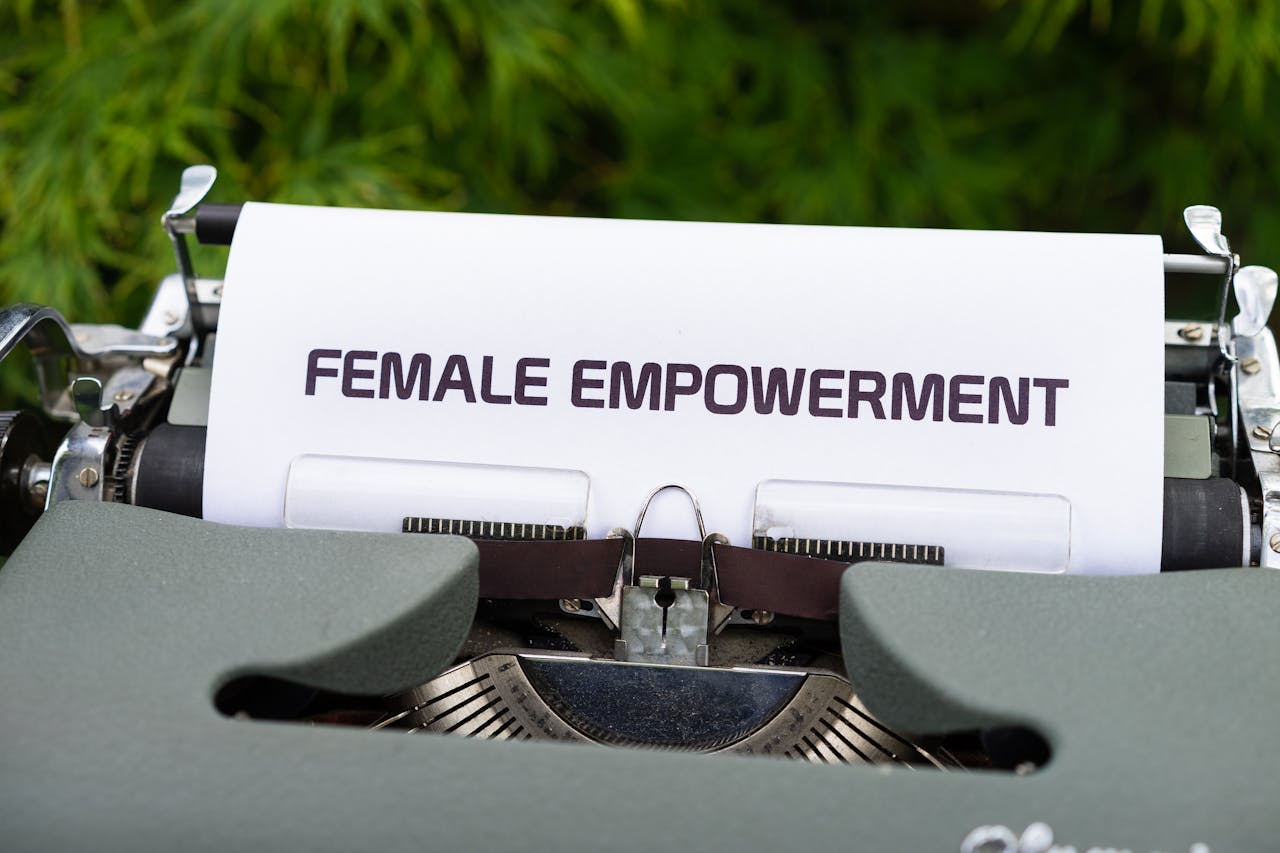 Close-up of a typewriter typing 'Female Empowerment' inspiring gender equality.